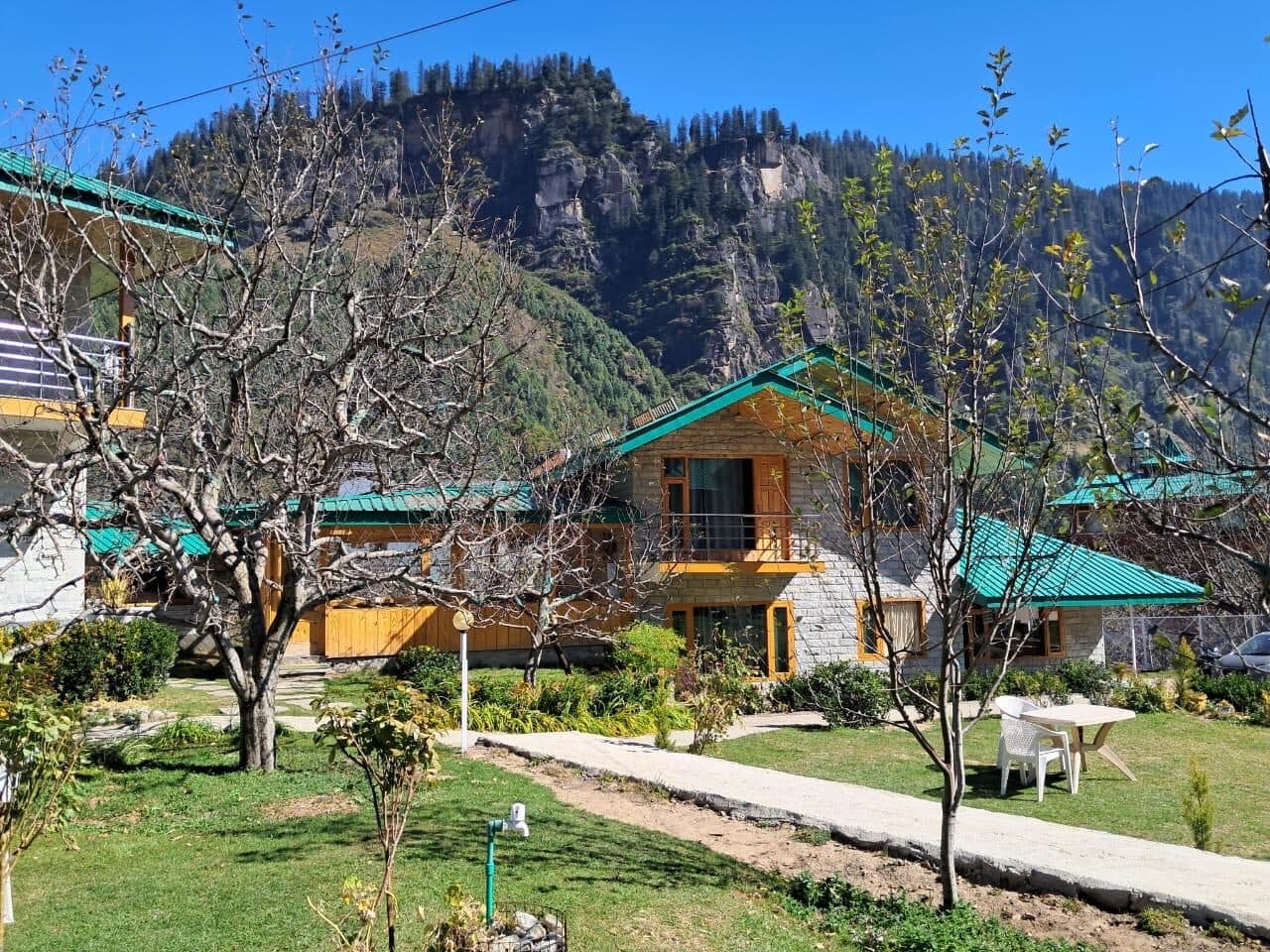 Wooden chalets on the open orchard lawns at Shanag