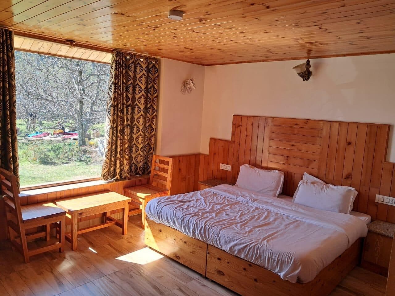 A pine-panelled room at Shanag with a mountain-view window